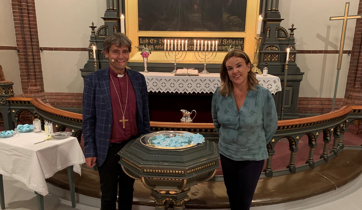 Biskop Stein Reinertsen og Tania Michelet ved d&#248;pefonten i Trefoldighetskirken i Arendal. Foto: Dag A. Kvarstein
