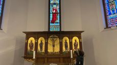 Prostiprest Hilde-Anette Løvenskiold Grüner tenner et lys før pilegrimene kommer.