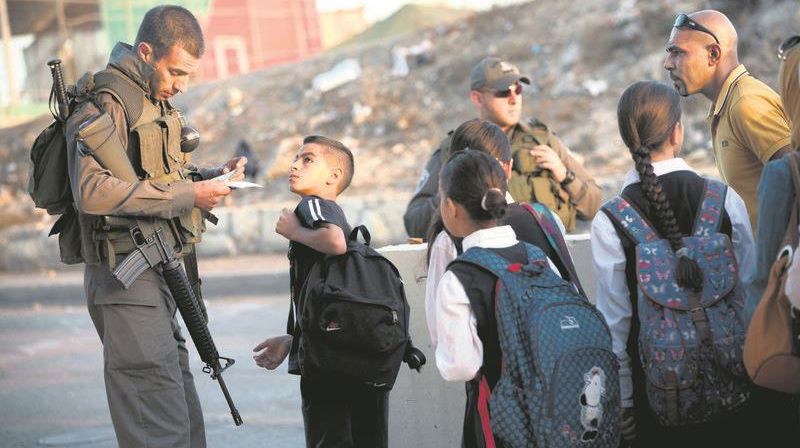 Students cross a checkpoint in the occupied west bank.