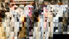 Sokneprest Jon-Geir Dittmann med noen av dåpskjolene som utstilles. Foto: Tore Dvergastein