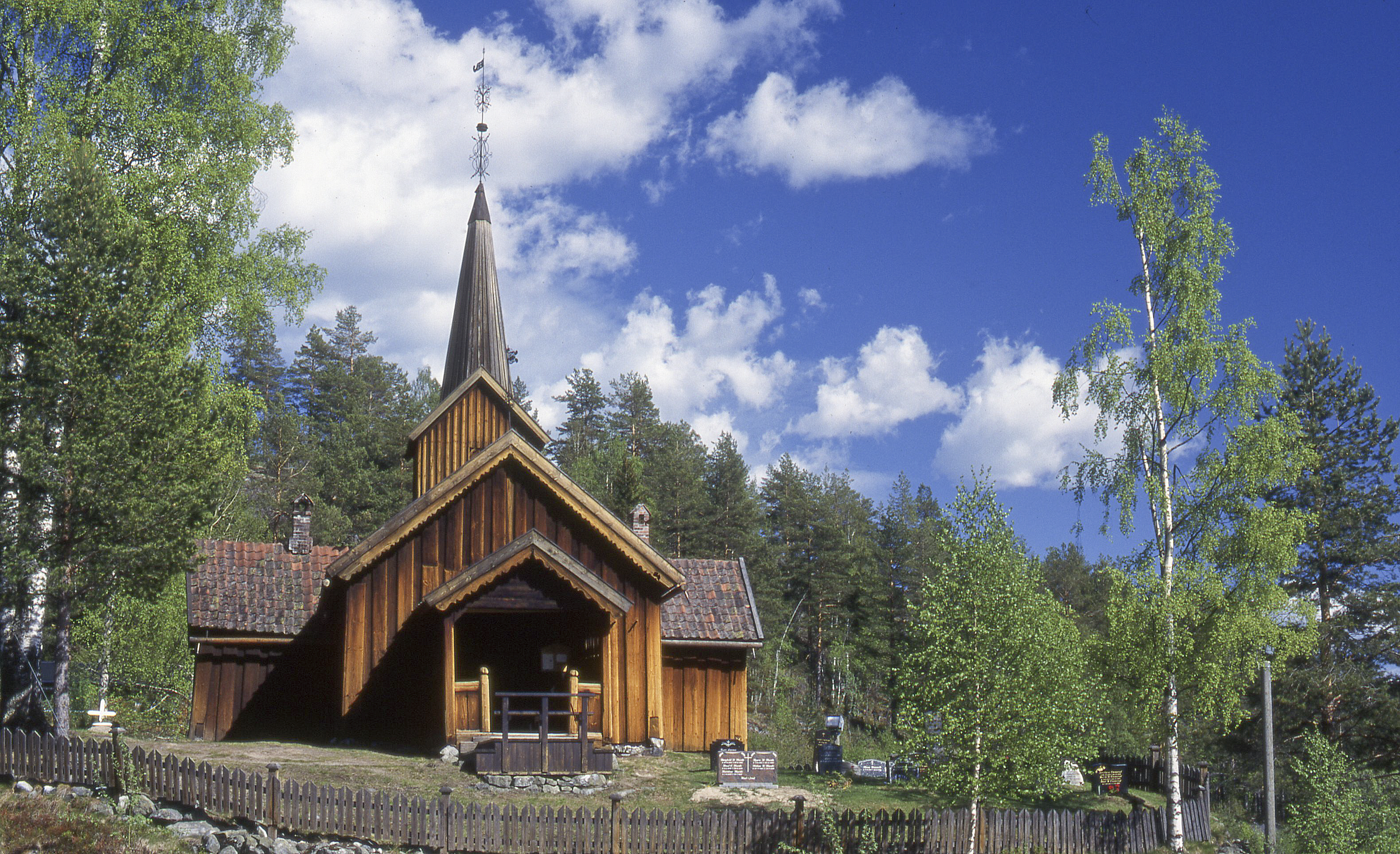 Vatn&#229;s kirke fra 1665 er en laftet korskirke. Like ved kirken er det en Olavskilde. Det heter seg at kilden har helbredende vann og at den aldri g&#229;r t&#248;rr. Foto: Tor Kornstad.