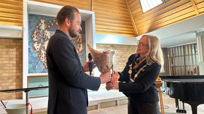 Ordfører Birgitta Gulla Løken overrekker blomster til konstituert kirkeverge Jan Einar Bjerke Hals.
